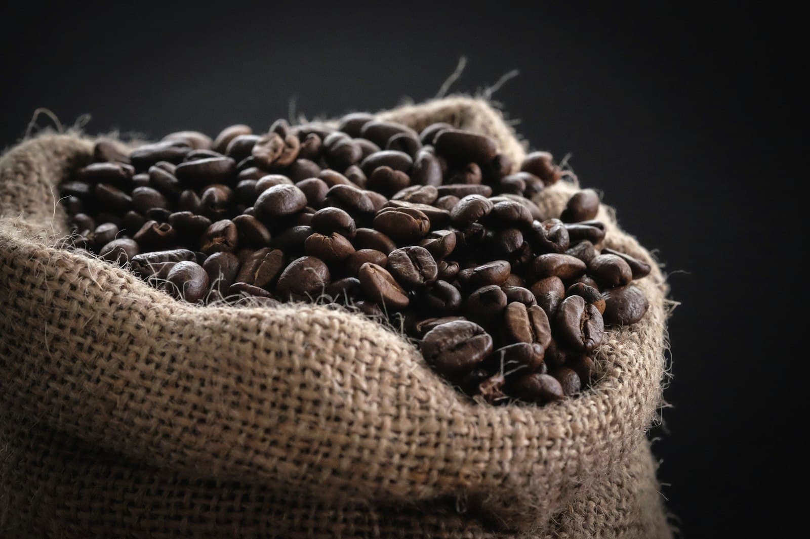 Sac de jute rempli de grains de café torréfiés, prêt à livrer